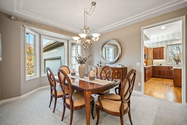 carpeted dining room featuring an inviting chandelier