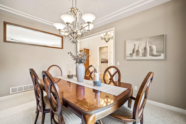 dining area featuring light colored carpet and a notable chandelier