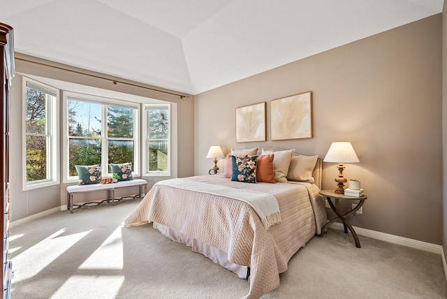 carpeted bedroom with lofted ceiling