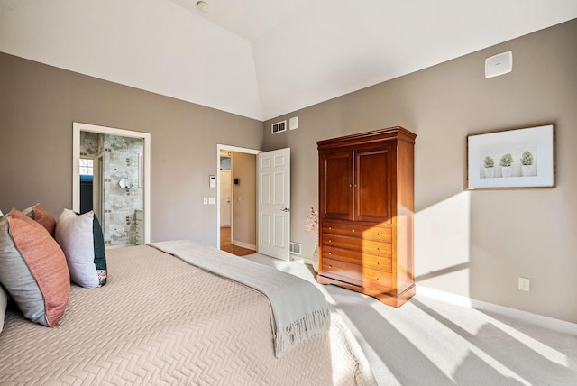 carpeted bedroom featuring connected bathroom and lofted ceiling