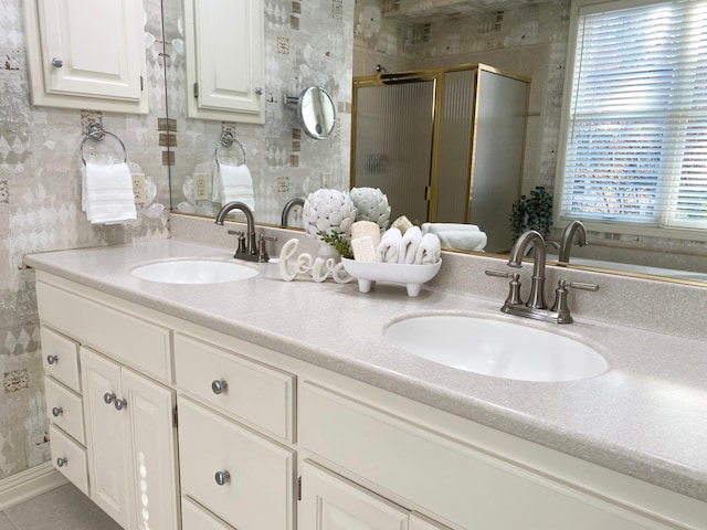 bathroom featuring tile patterned floors, vanity, and an enclosed shower