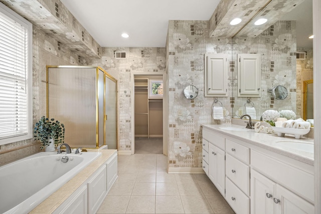 bathroom featuring tile patterned flooring, vanity, a healthy amount of sunlight, and separate shower and tub