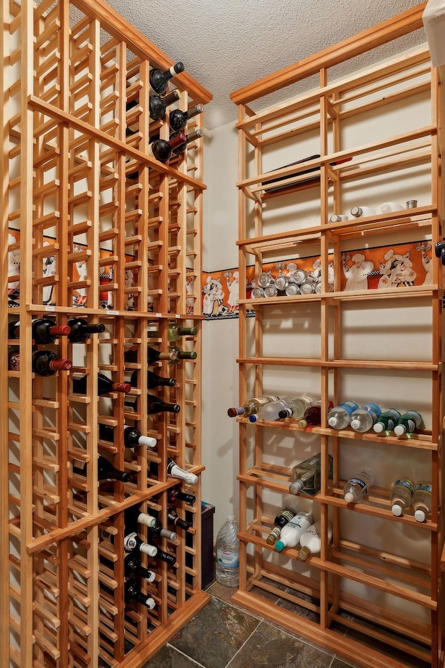 wine area featuring a textured ceiling