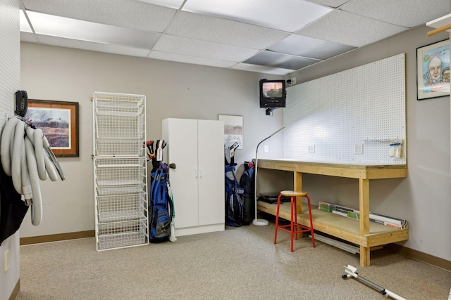 bedroom featuring a paneled ceiling and a workshop area