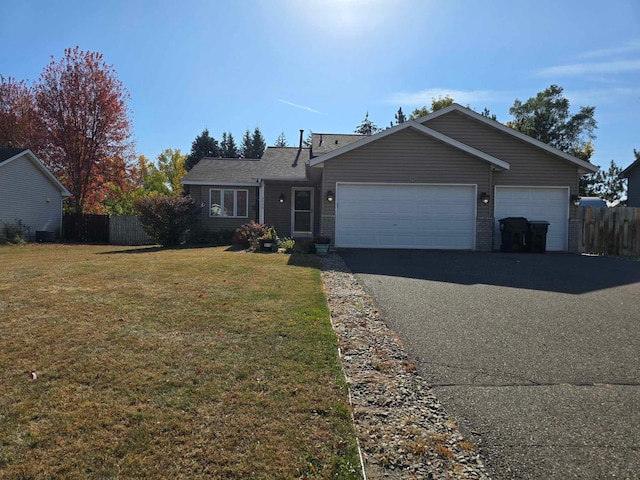 ranch-style house featuring a garage and a front lawn