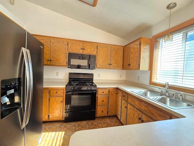 kitchen with black appliances, sink, hanging light fixtures, vaulted ceiling, and light tile patterned flooring