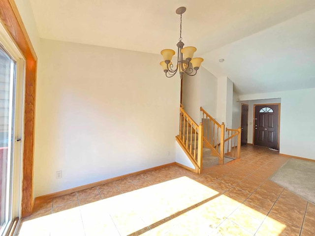 foyer entrance featuring tile patterned floors, a notable chandelier, and lofted ceiling