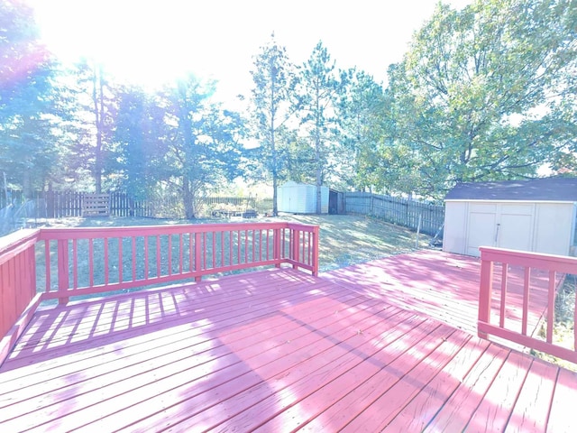 wooden terrace featuring a shed