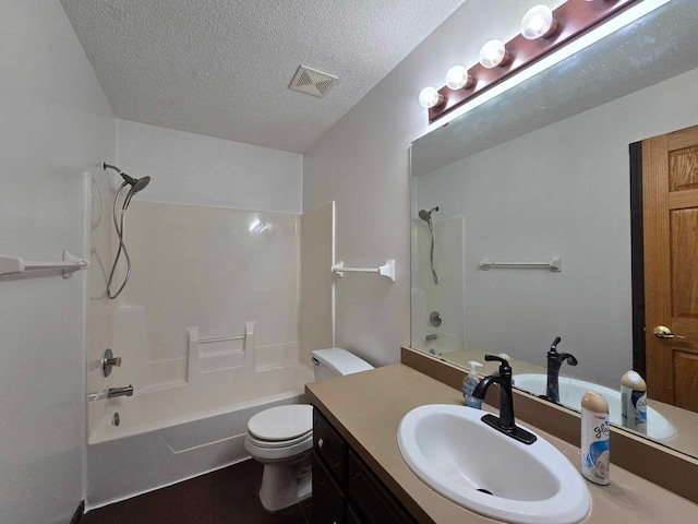 full bathroom with vanity,  shower combination, toilet, and a textured ceiling