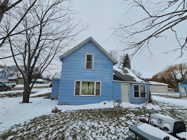 view of snow covered back of property