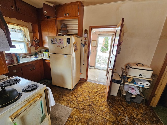 kitchen featuring electric stove and white refrigerator