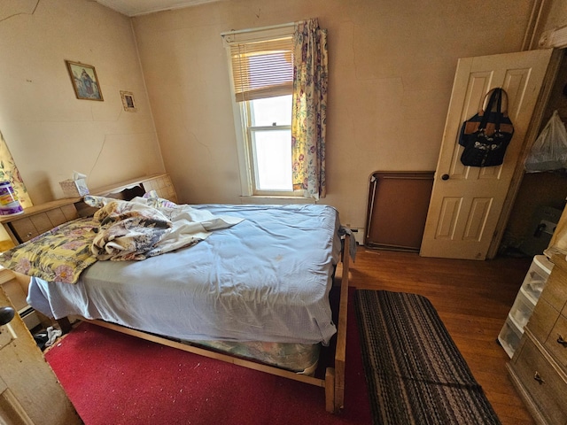 bedroom with dark wood-type flooring