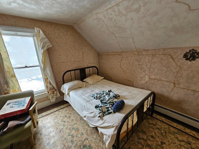 bedroom featuring baseboard heating and lofted ceiling