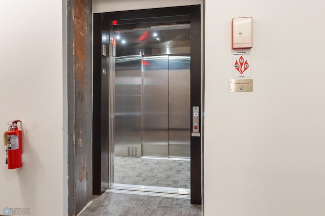 interior details with a fire extinguisher and elevator