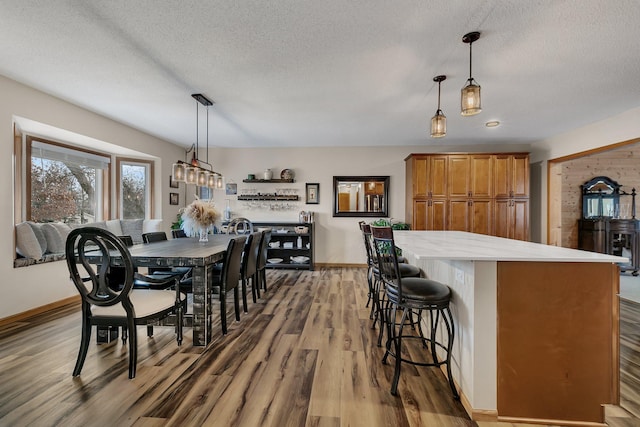 dining room featuring a textured ceiling and hardwood / wood-style flooring