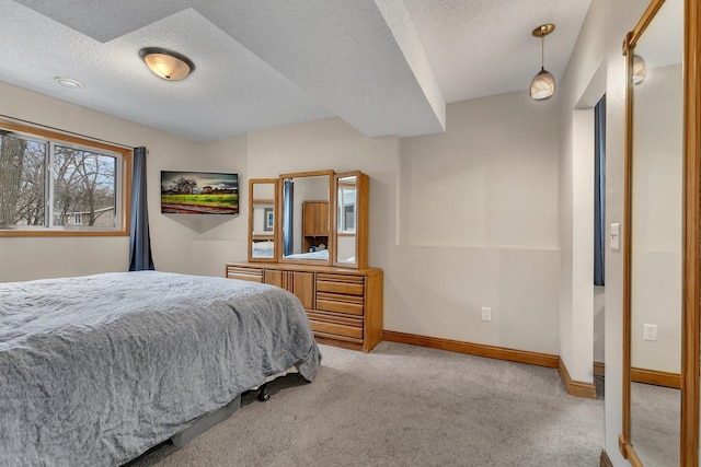 bedroom featuring light carpet and a textured ceiling