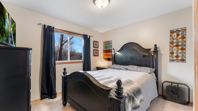 bedroom with light carpet and a textured ceiling