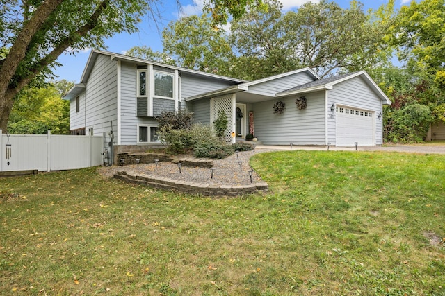 view of front of home featuring a front yard and a garage