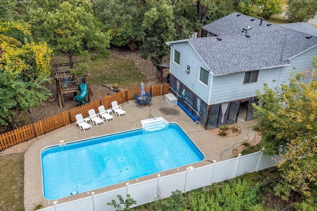 view of pool with a playground and a patio area