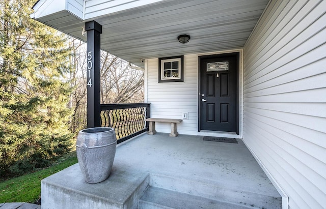 view of exterior entry featuring covered porch