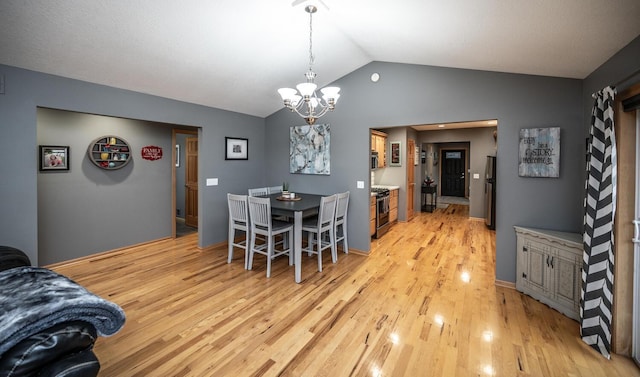 dining space with a chandelier, light wood-type flooring, and vaulted ceiling