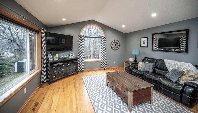 living room featuring light hardwood / wood-style flooring and vaulted ceiling