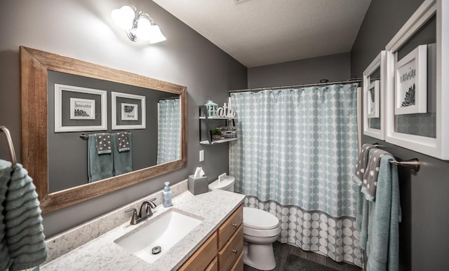 bathroom with vanity, a textured ceiling, and toilet