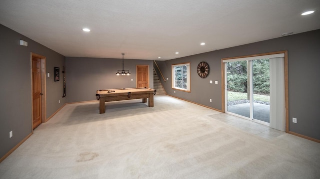 game room with light carpet, a textured ceiling, and pool table