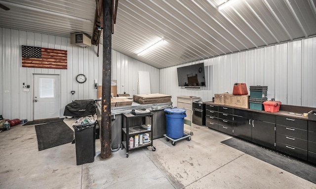 garage with a workshop area and wooden walls