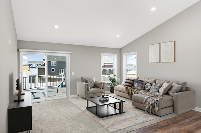 living room featuring lofted ceiling and hardwood / wood-style floors