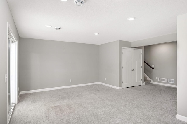 empty room featuring light colored carpet