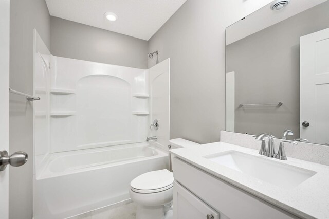 full bathroom with vanity, washtub / shower combination, and toilet