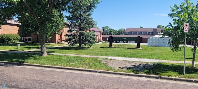 view of home's community with a yard