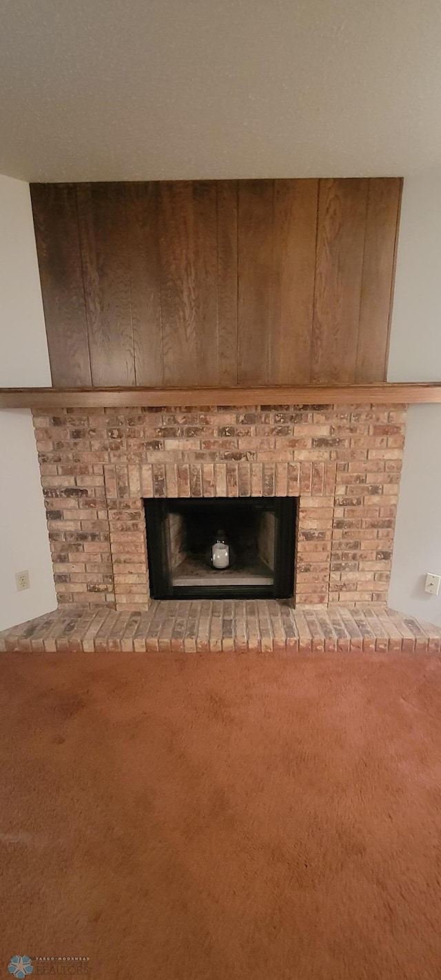 details featuring carpet and a brick fireplace