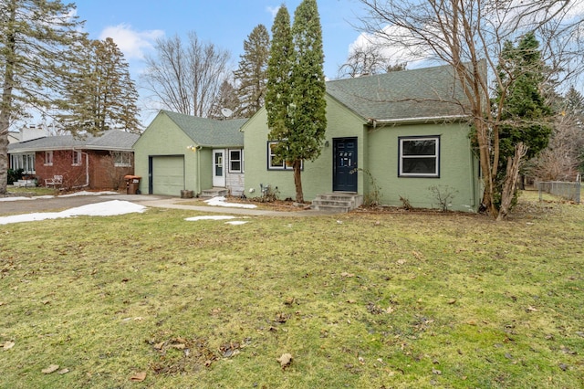 view of front of home with a front yard and a garage