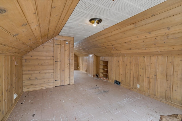 additional living space featuring wood walls, wood ceiling, and vaulted ceiling