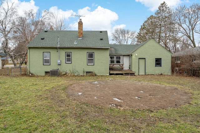 back of property with a lawn, cooling unit, and a deck