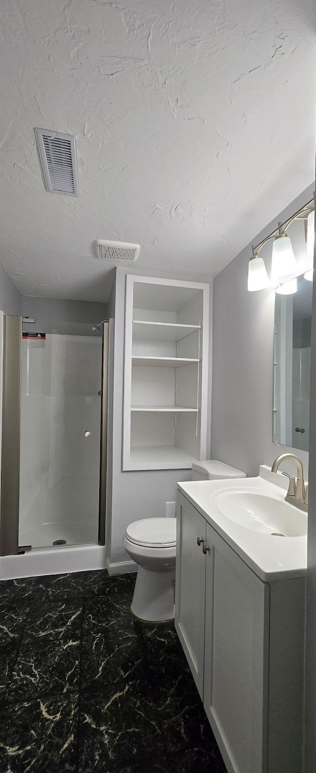 bathroom with a stall shower, visible vents, vanity, and a textured ceiling