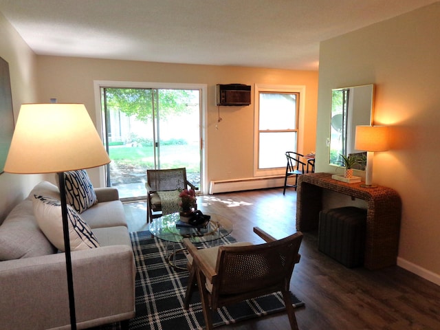 living room with a wall mounted air conditioner, dark wood-type flooring, and a baseboard heating unit