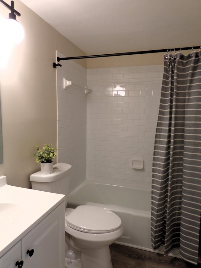 bathroom featuring wood-type flooring, vanity, and toilet