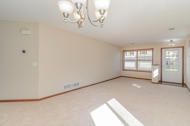 interior space featuring carpet and an inviting chandelier