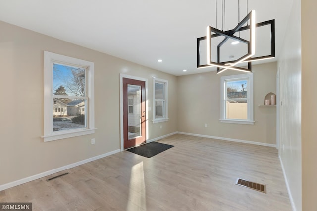 interior space with light hardwood / wood-style flooring and a wealth of natural light