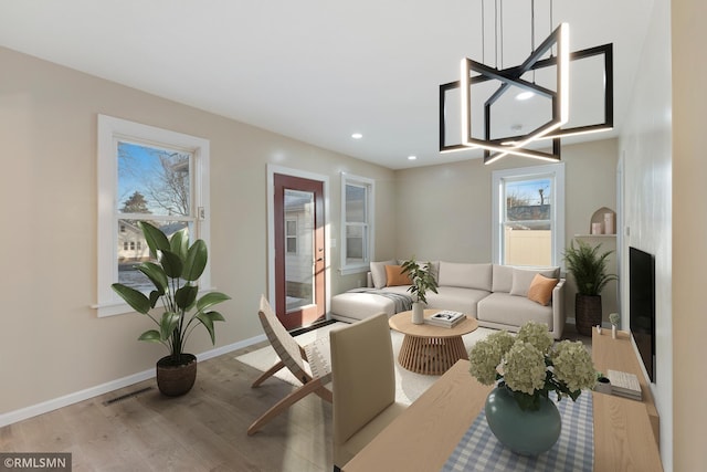 dining space featuring plenty of natural light and light hardwood / wood-style floors