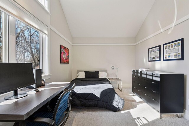 bedroom with high vaulted ceiling, baseboards, and light colored carpet