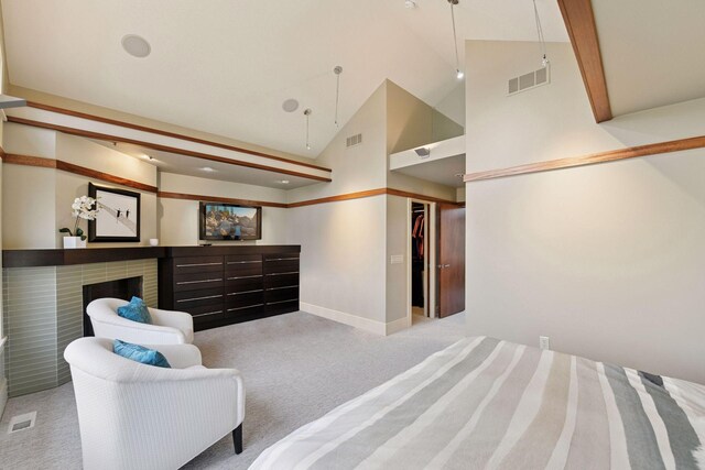 carpeted bedroom featuring baseboards, a brick fireplace, high vaulted ceiling, and visible vents
