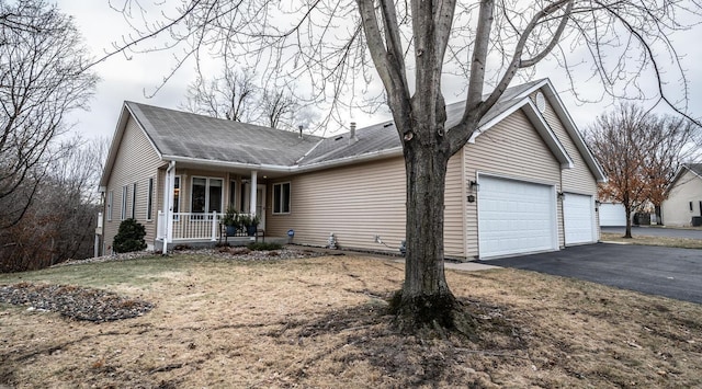 view of front of house with covered porch and a garage