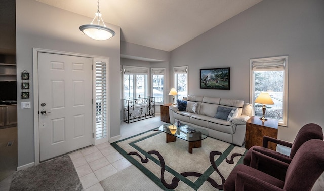 living room featuring lofted ceiling and light tile patterned floors