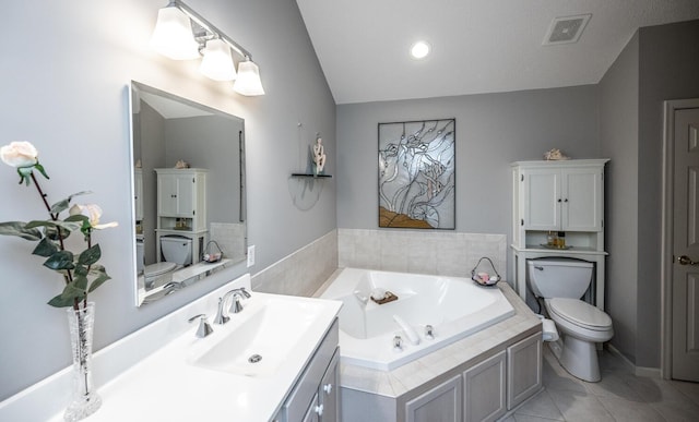 bathroom with tile patterned floors, vanity, tiled bath, toilet, and lofted ceiling