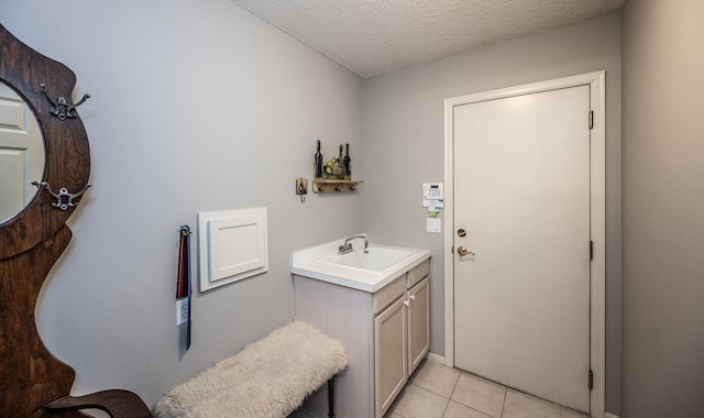 bathroom with vanity, a textured ceiling, and tile patterned floors