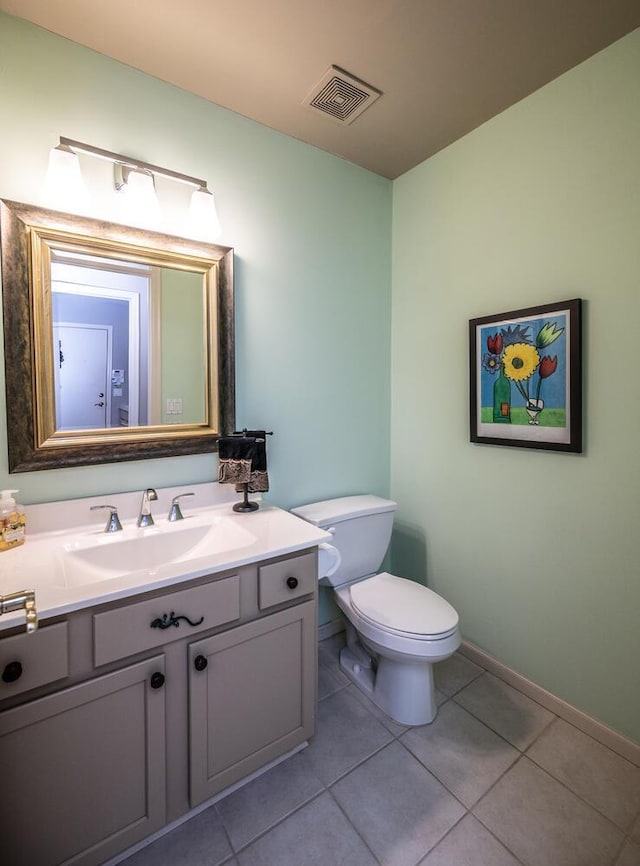 bathroom featuring tile patterned floors, vanity, and toilet